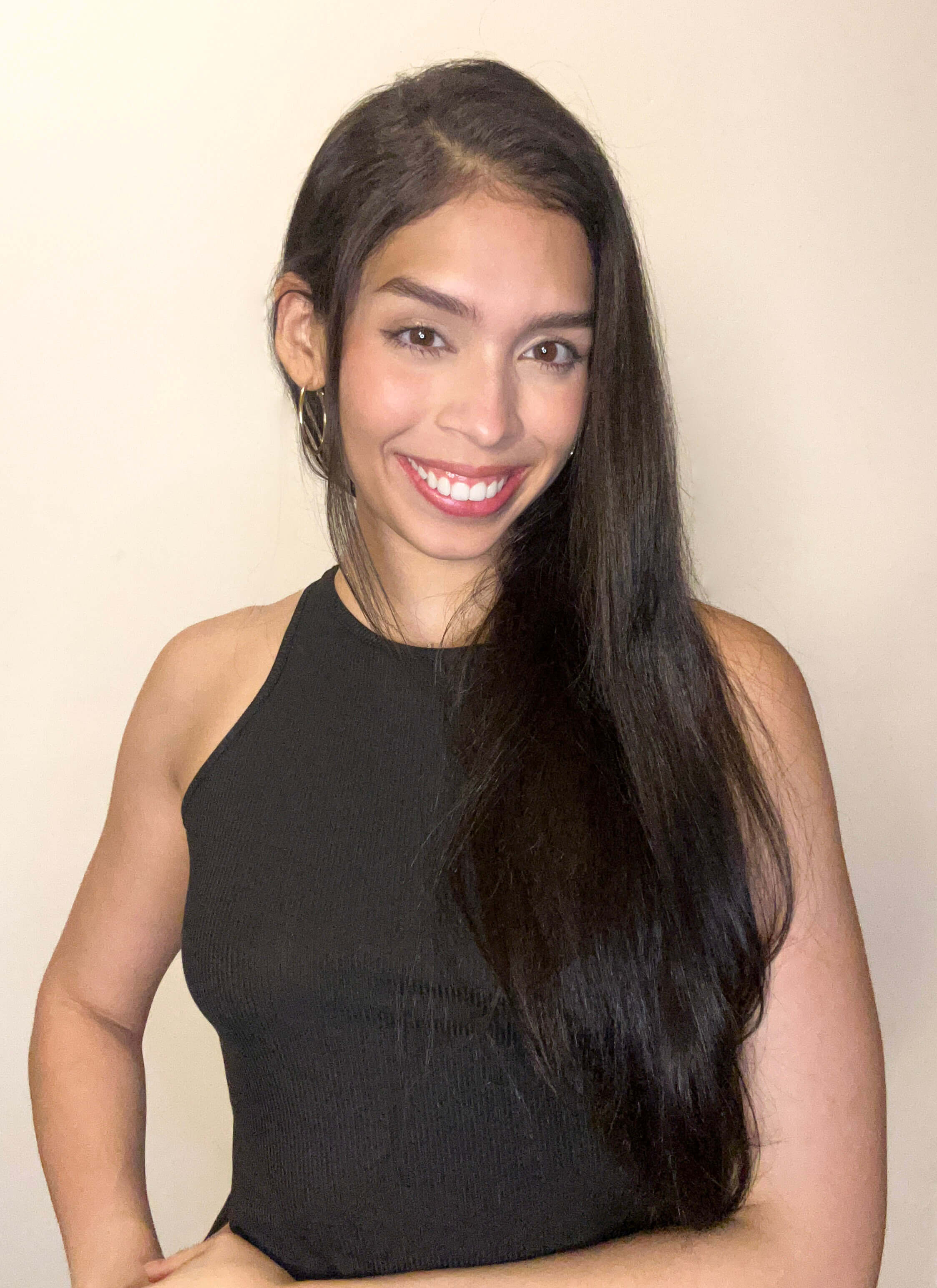 Jeanine White smiling in a red plaid shirt and tortoise shell glasses